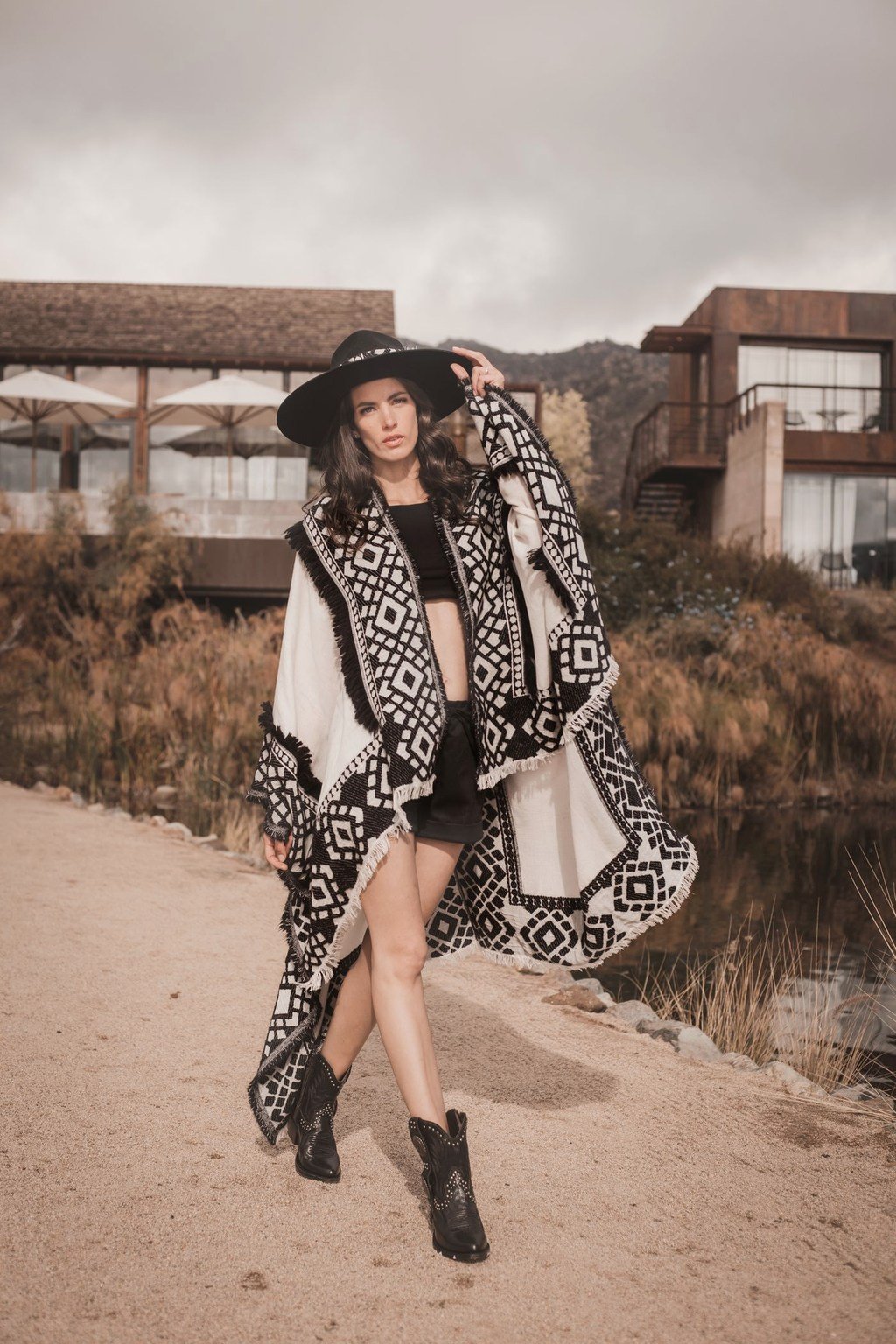 Woman wearing the Ada black-and-cream patterned wool poncho
